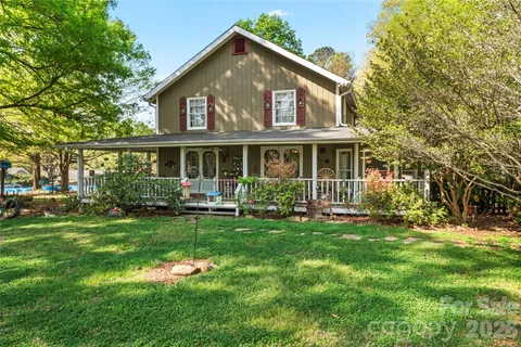 a front view of a house with a yard table and chairs