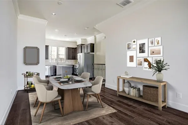 a view of a dining room with furniture a fireplace and wooden floor