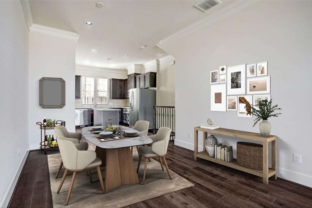 a view of a dining room with furniture a fireplace and wooden floor