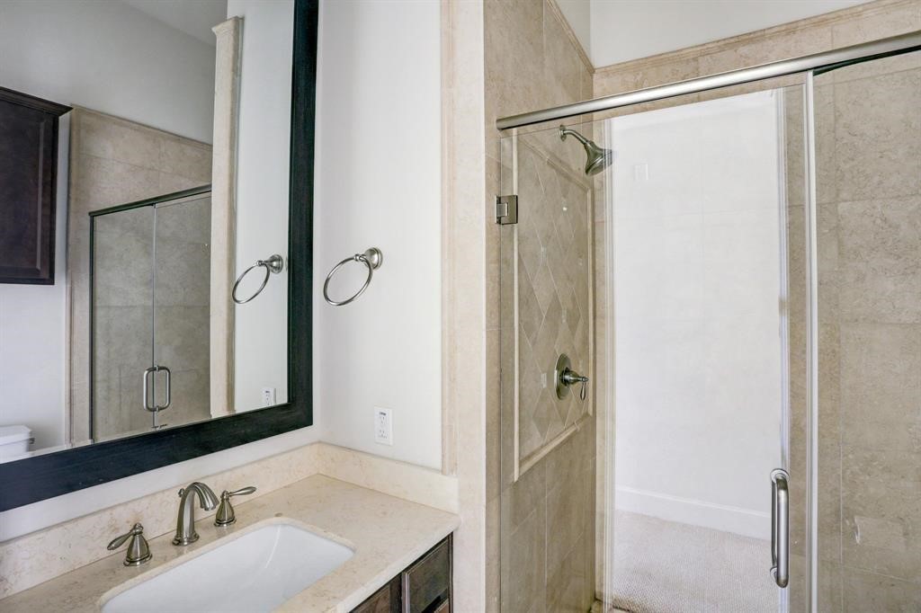 9676 Knight Road Houston, TX 77045 - Photo 6 of 11 a bathroom with a sink and a mirror