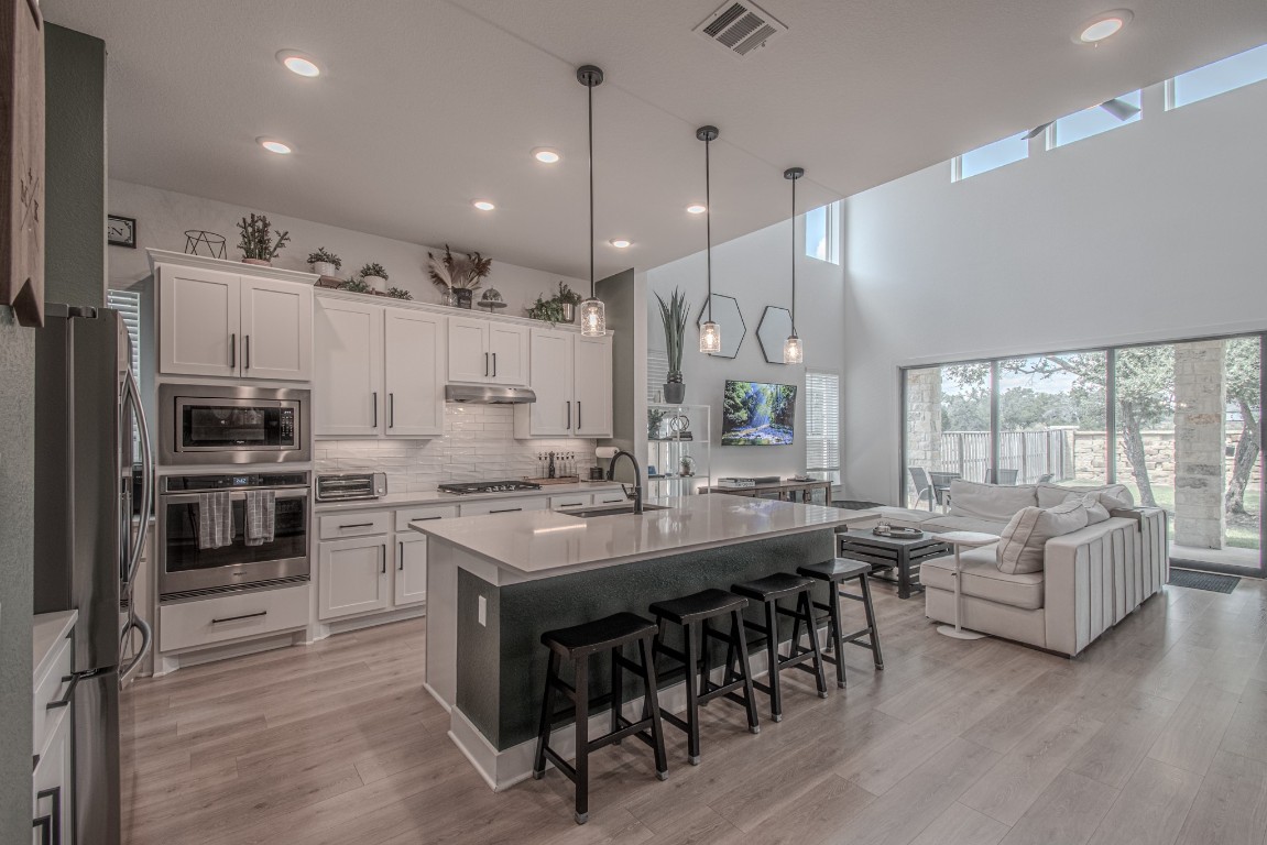 308 Millbend Road Georgetown, TX 78633 - Photo 1 of 40 a kitchen with counter top space a sink appliances and living room view