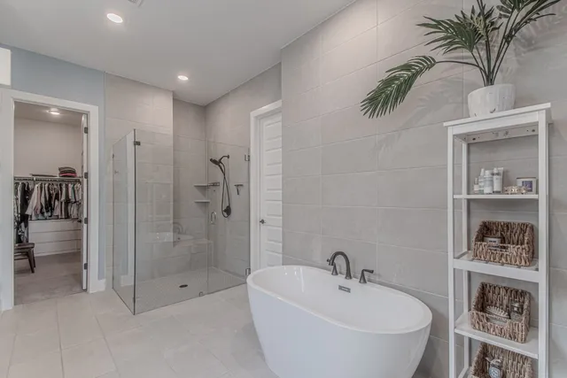 a spacious bathroom with a granite countertop sink a toilet a mirror and shower