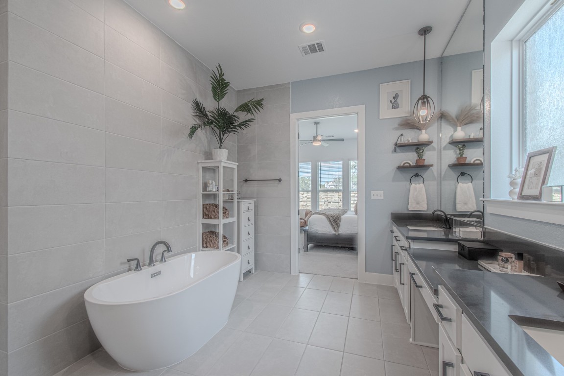 308 Millbend Road Georgetown, TX 78633 - Photo 17 of 40 a bathroom with a tub sink and mirror