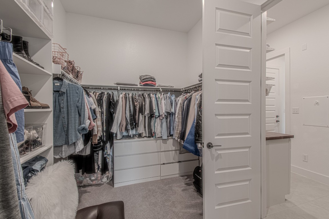 308 Millbend Road Georgetown, TX 78633 - Photo 18 of 40 a view of walk in closet with clothes and shoes