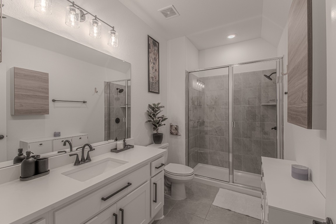 308 Millbend Road Georgetown, TX 78633 - Photo 25 of 40 a bathroom with a double vanity sink toilet and shower