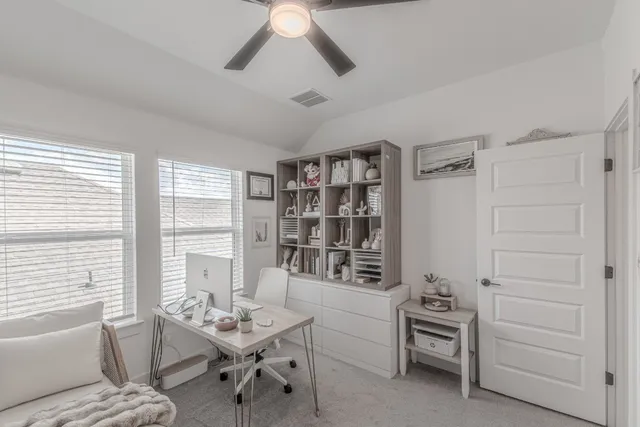 a bedroom with furniture and a large window