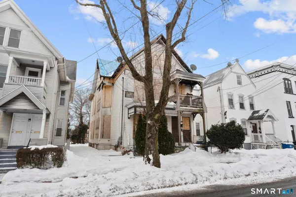 a view of a house with snow on the road