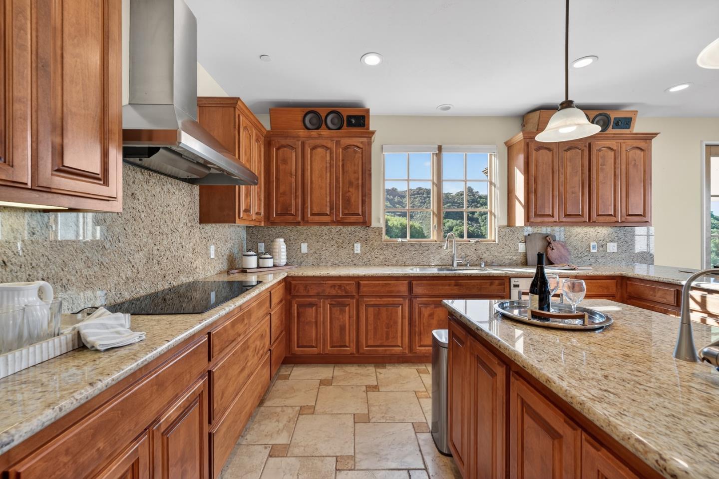 17599 Montebello Road Cupertino, CA 95014 - Photo 22 of 83 a kitchen with granite countertop a sink a counter space appliances and cabinets