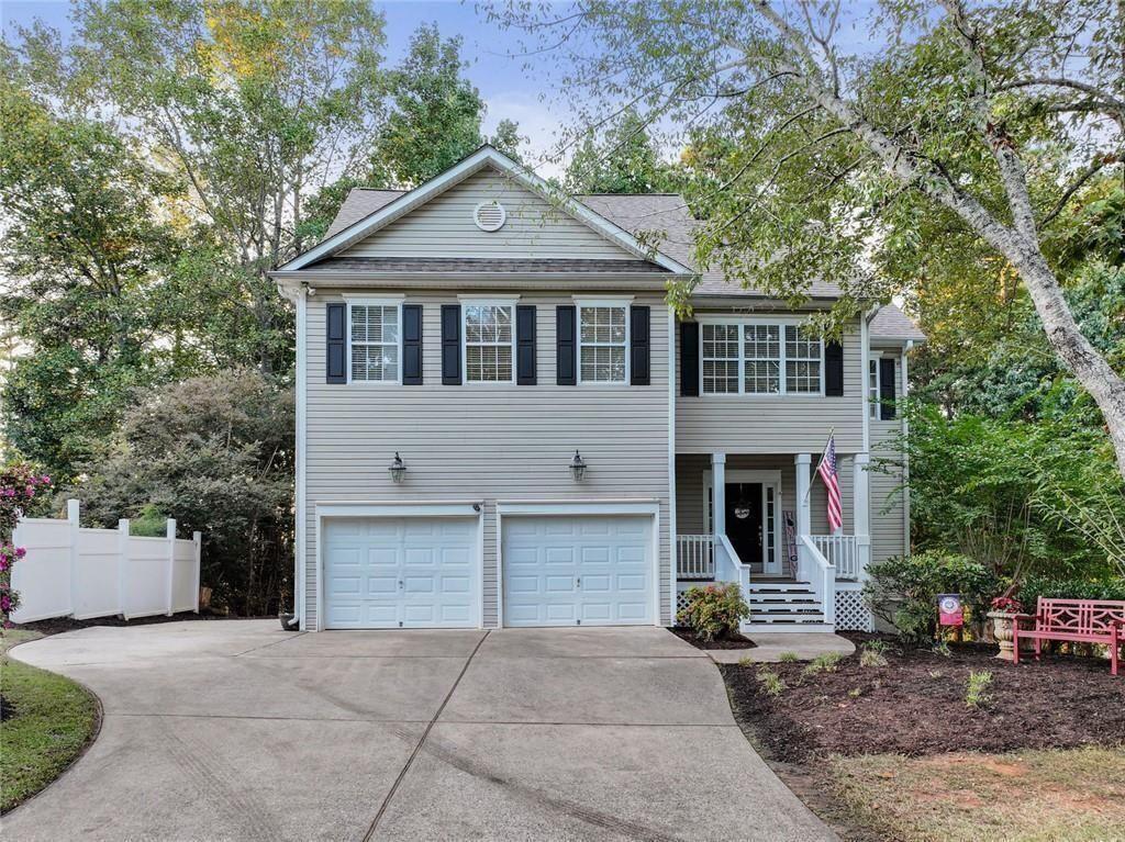 4715 Fowler Trail Cumming, GA 30041 - Photo 1 of 1 a front view of a house with a yard and garage