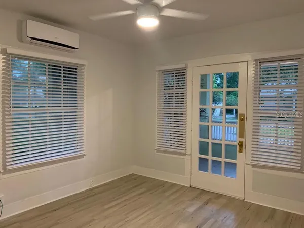 a view of wooden floor and windows in a room
