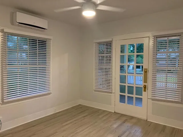 a view of wooden floor and windows in a room