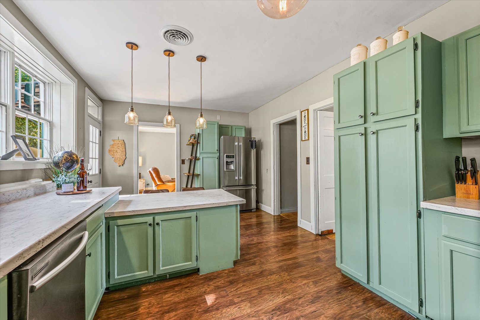 824 Arends Boulevard Rantoul, IL 61866 - Photo 16 of 38 a room with kitchen island stainless steel appliances a sink cabinets and a window