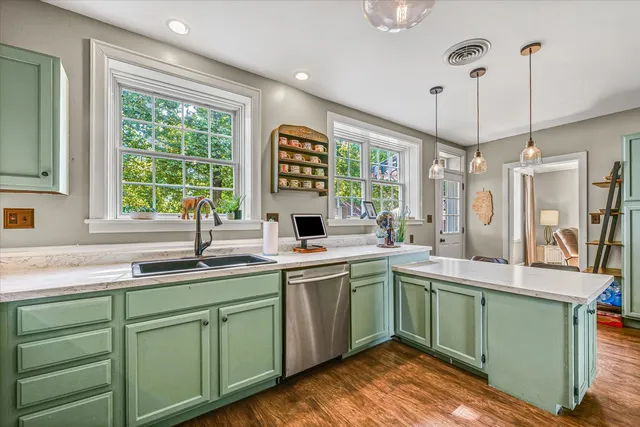 a kitchen with a sink window and cabinets