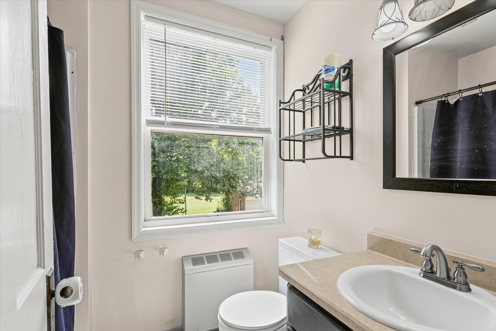 824 Arends Boulevard Rantoul, IL 61866 - Photo 22 of 38 a bathroom with a toilet a sink and a window