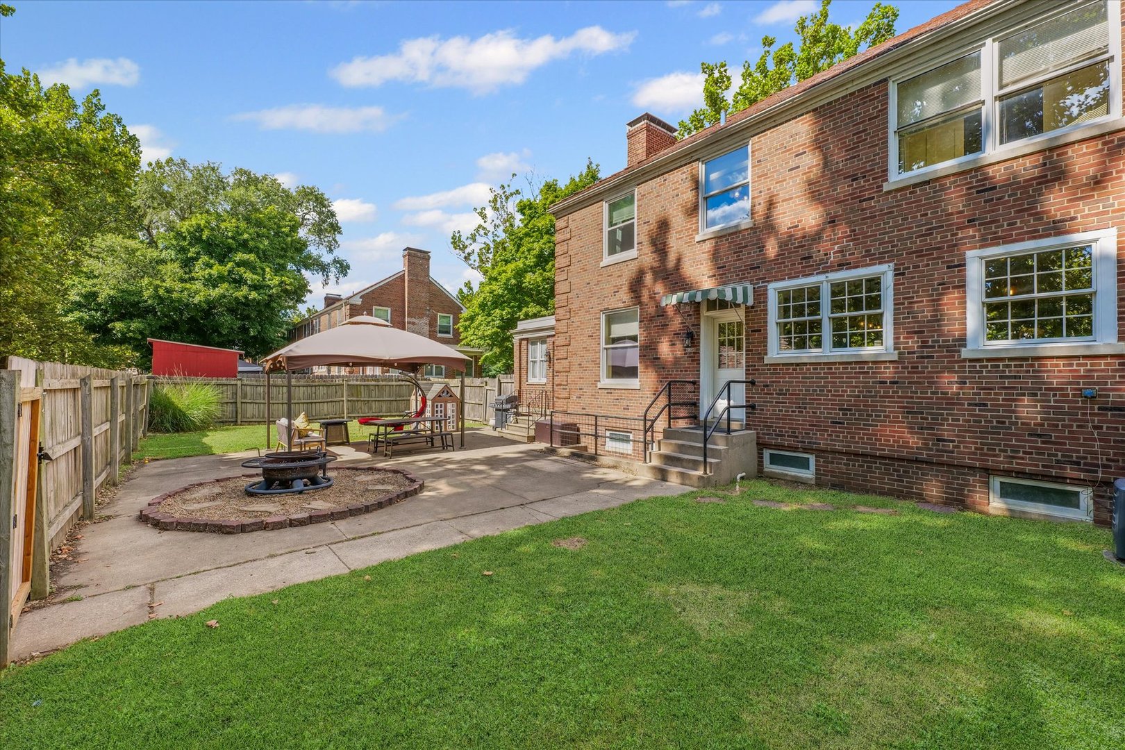 824 Arends Boulevard Rantoul, IL 61866 - Photo 36 of 38 a patio with a table and chairs under an umbrella