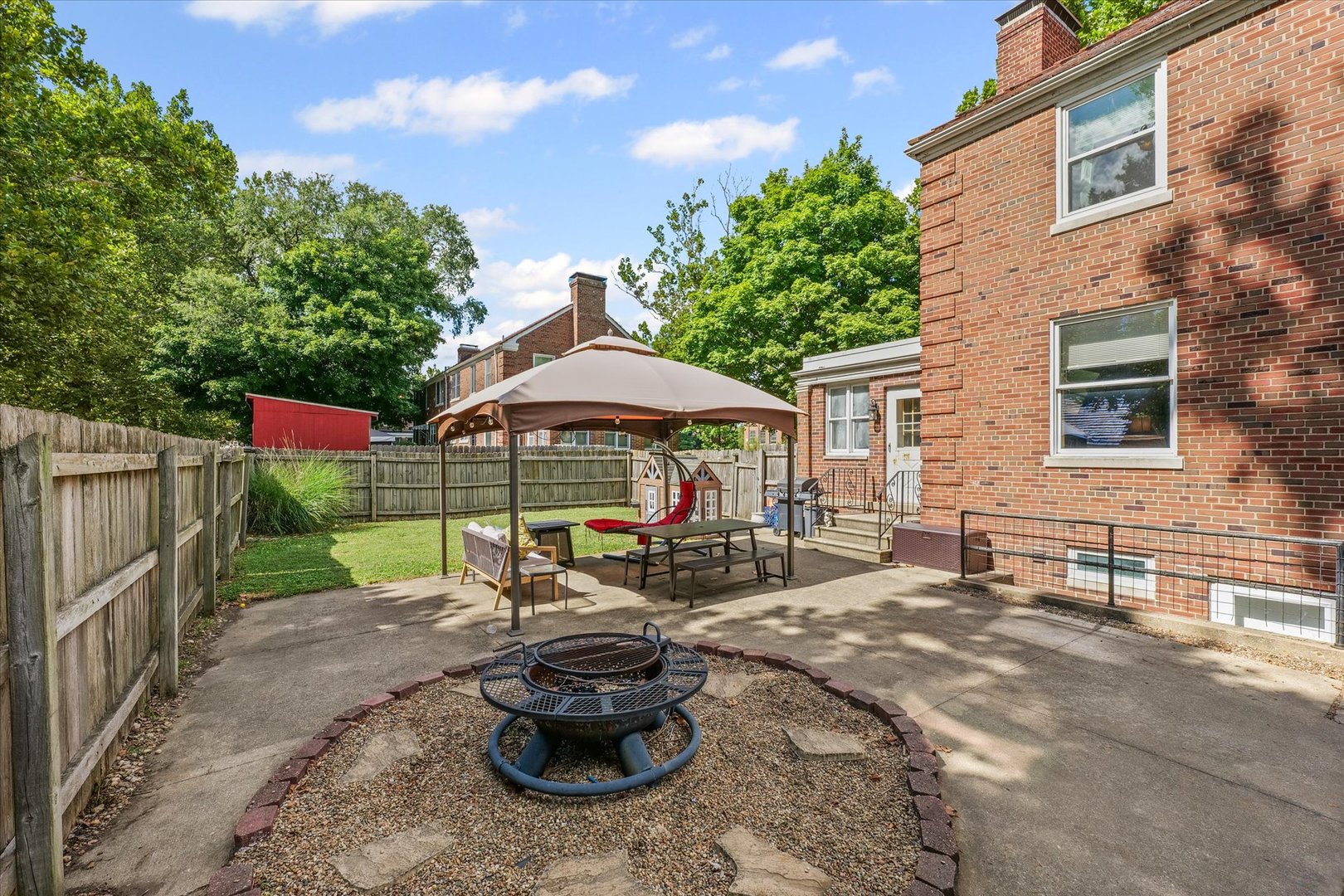 824 Arends Boulevard Rantoul, IL 61866 - Photo 37 of 38 a view of a backyard with table and chairs under an umbrella