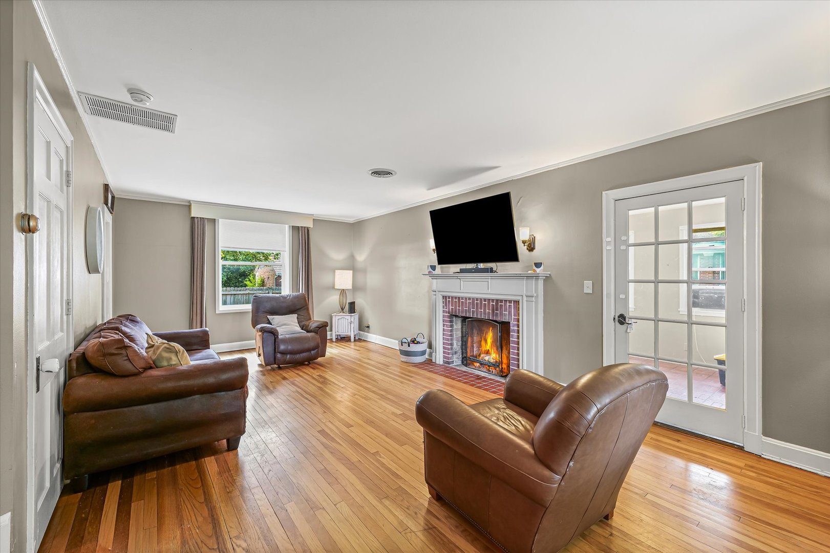 824 Arends Boulevard Rantoul, IL 61866 - Photo 6 of 38 a living room with furniture a fireplace and a flat screen tv
