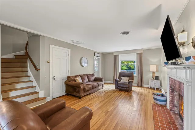 a living room with furniture a fireplace and a flat screen tv