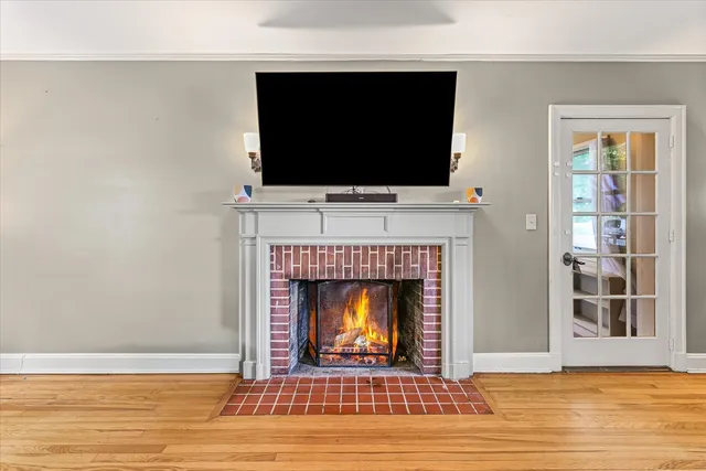 a living room with a fireplace and a flat screen tv