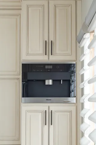 a view of kitchen with stainless steel appliances wooden floor and window