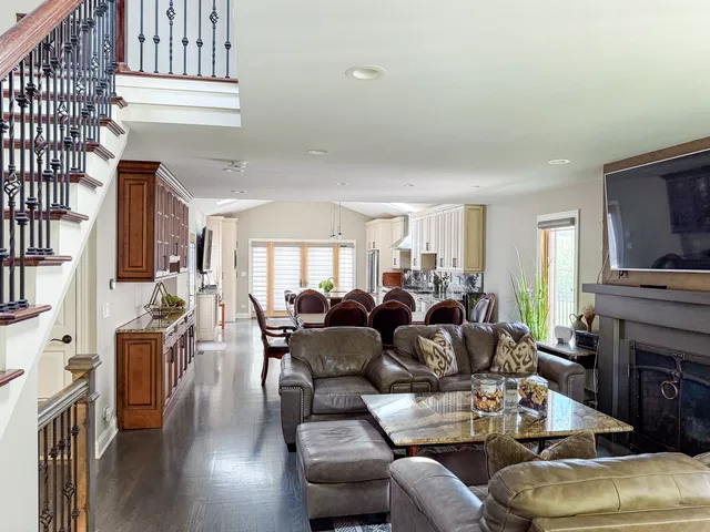 a living room with fireplace furniture and a wooden floor