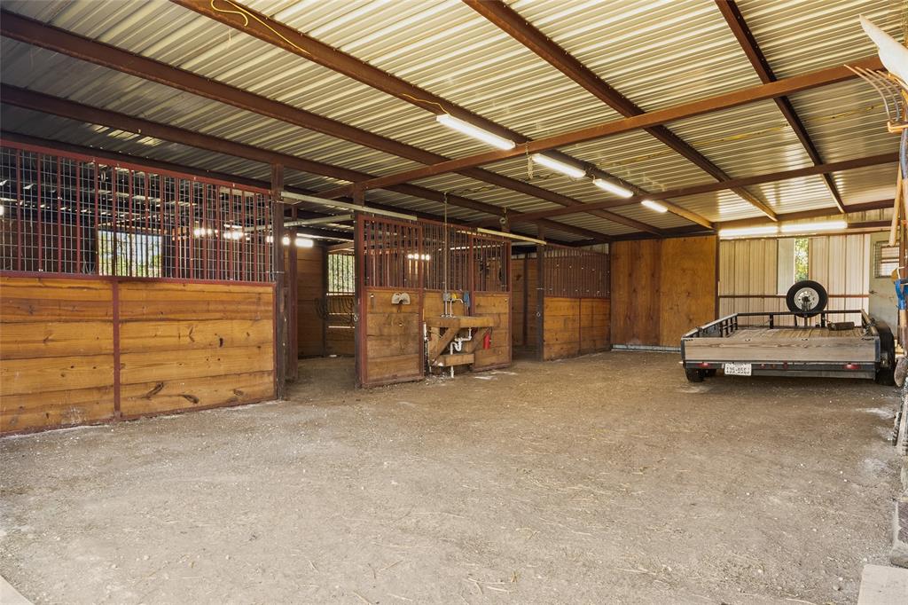 4451 Shiloh Road Midlothian, TX 76065 - Photo 32 of 39 Back side of barn has a lean to that can hold 250 square bails of hay. This area of the barn is not insulated. This area has a sink. This area of the barn has drive through doors.