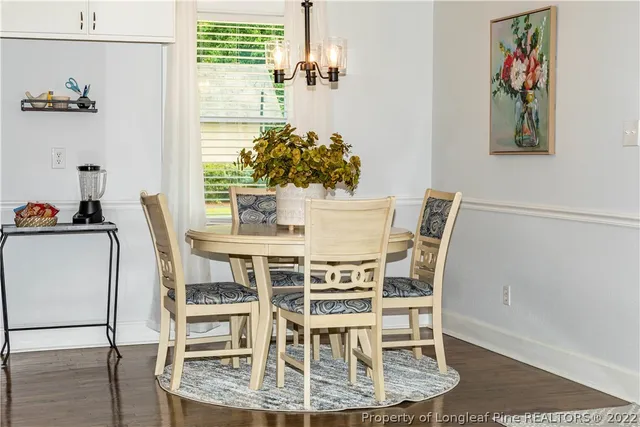 a dining room with furniture and window