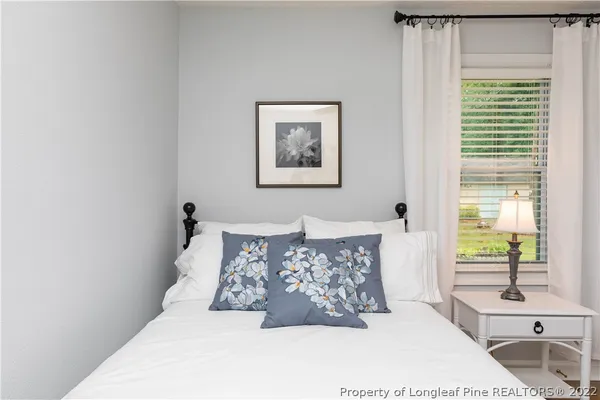 a bed sitting in a bedroom next to a window