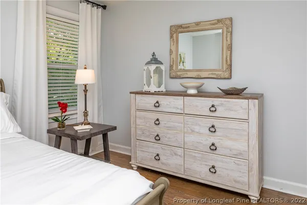 a bedroom with a bed and a dresser