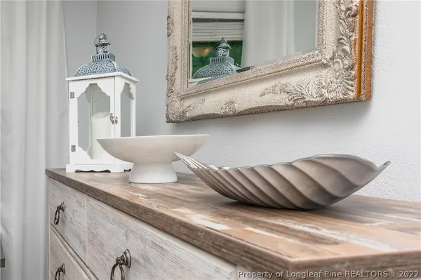 a bathroom with a window sink and mirror