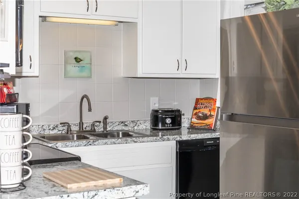 a kitchen with a sink a stove and cabinets