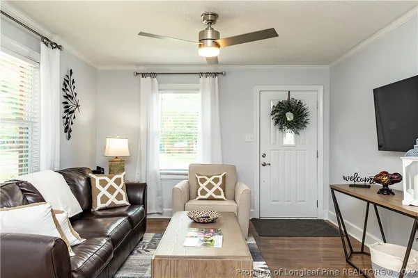 a living room with furniture and a flat screen tv