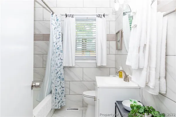 a bathroom with a sink and a shower curtain