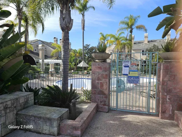 a view of a house with backyard and swimming pool