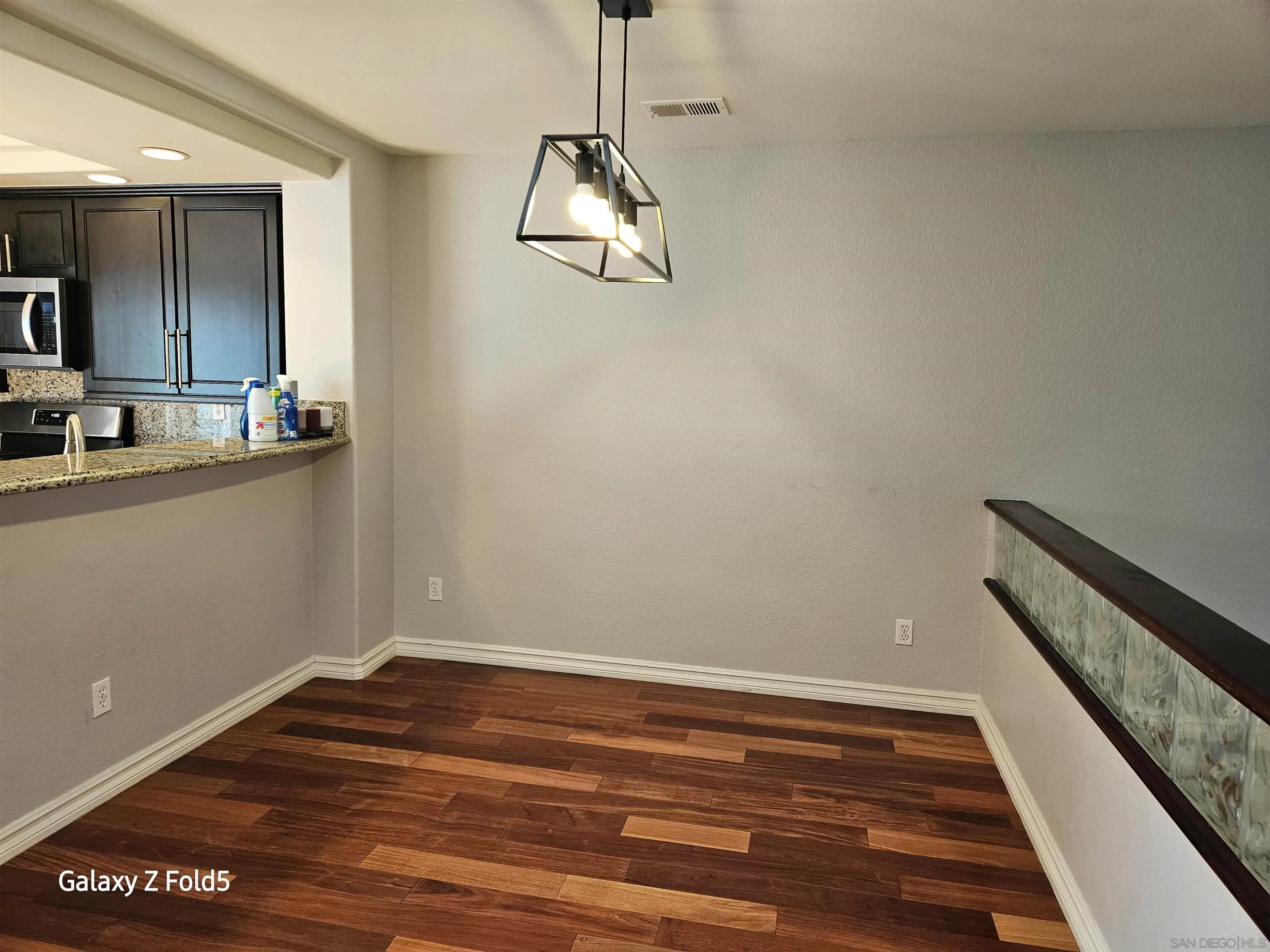 12980 Carmel Creek Road San Diego, CA 92130 - Photo 3 of 13 a view of a room with wooden floor and white walls