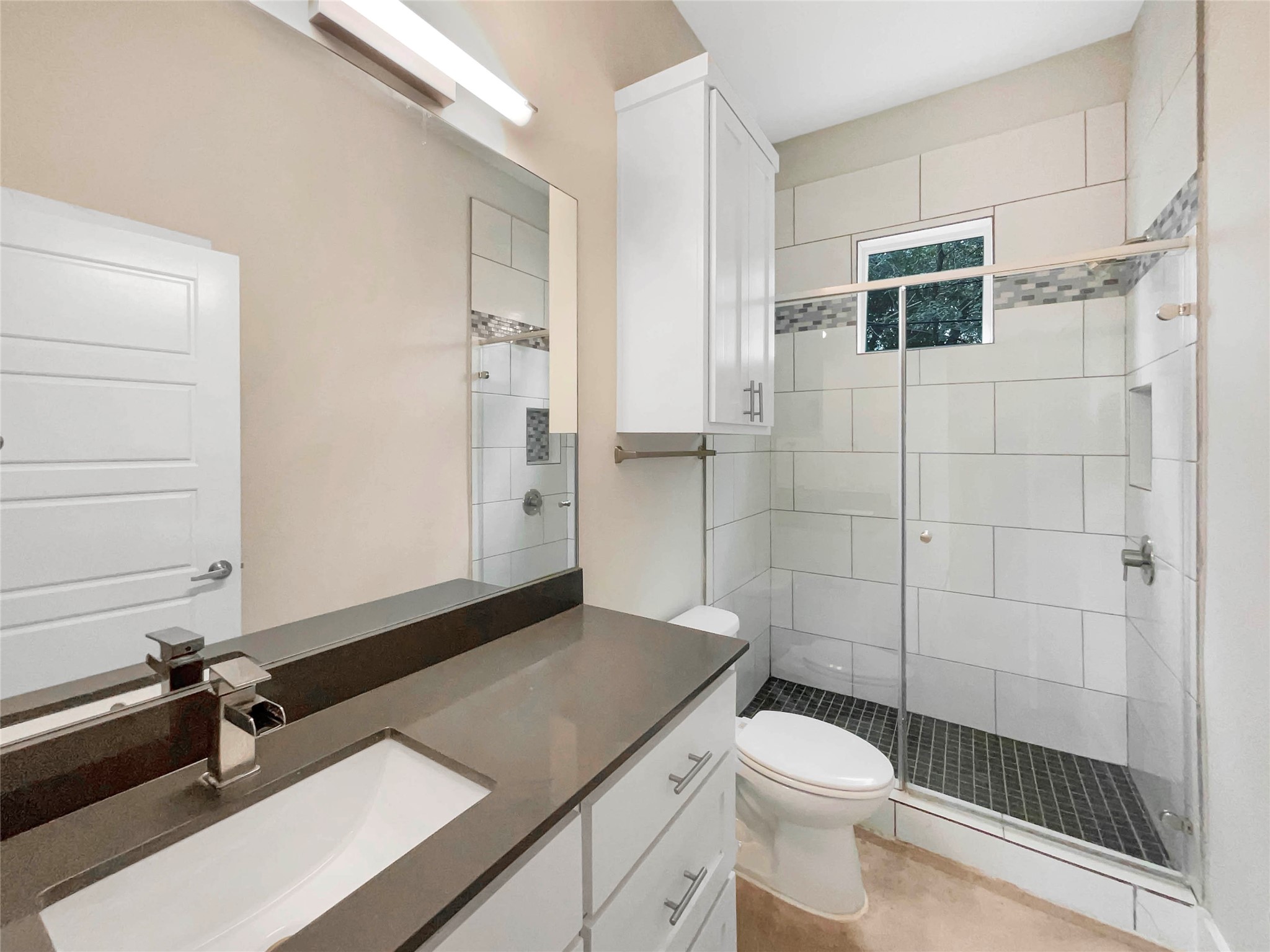 6213 Felix Avenue, Unit B Austin, TX 78741 - Photo 12 of 21 Full bath featuring a stall shower, vanity, and light tile patterned floors