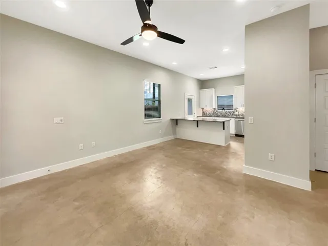 a view of a kitchen with a sink and a refrigerator