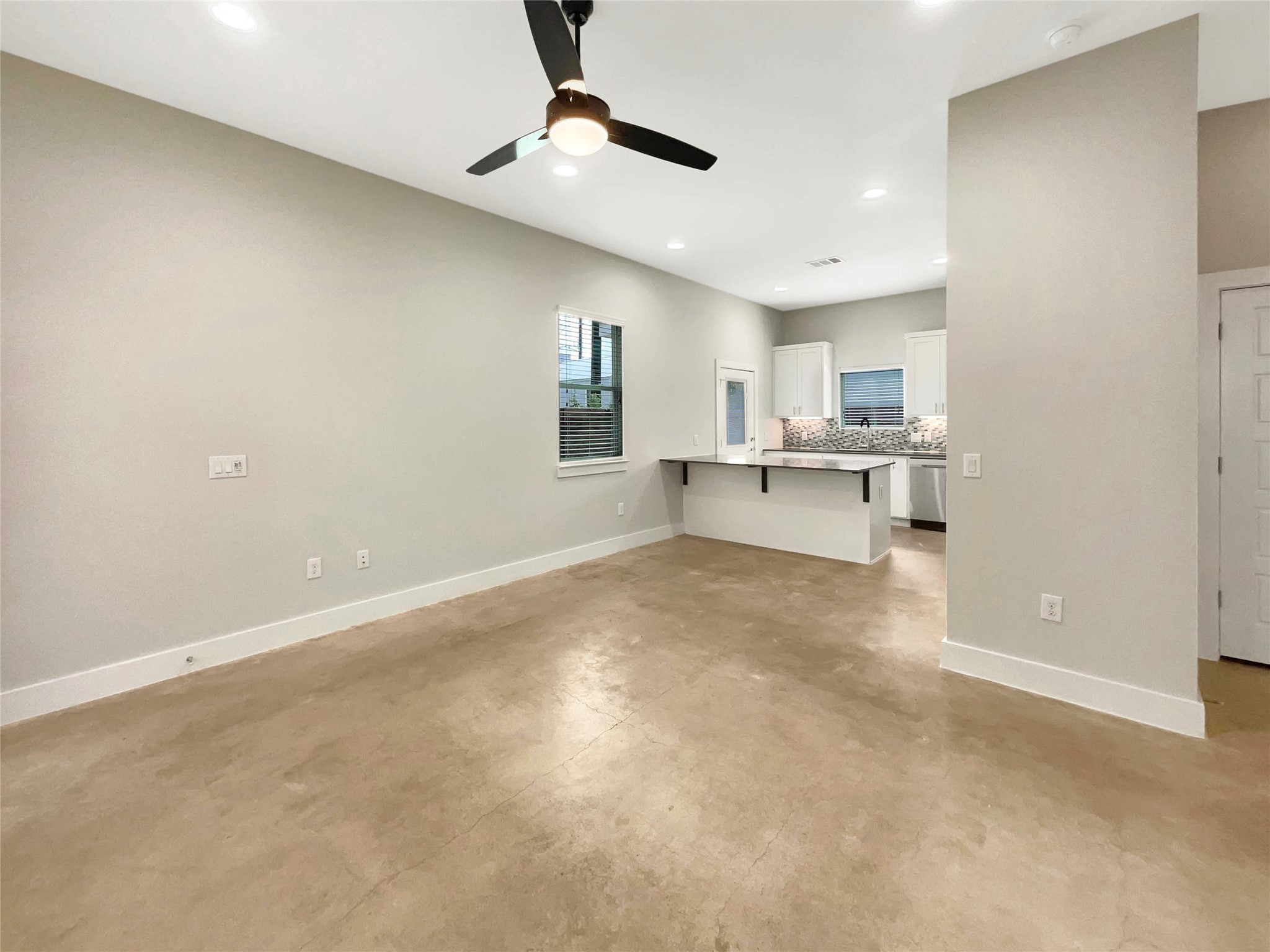 6213 Felix Avenue, Unit B Austin, TX 78741 - Photo 3 of 21 Unfurnished living room with finished concrete flooring, recessed lighting, and ceiling fan