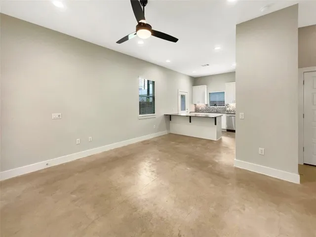 a view of a kitchen with a sink and a refrigerator