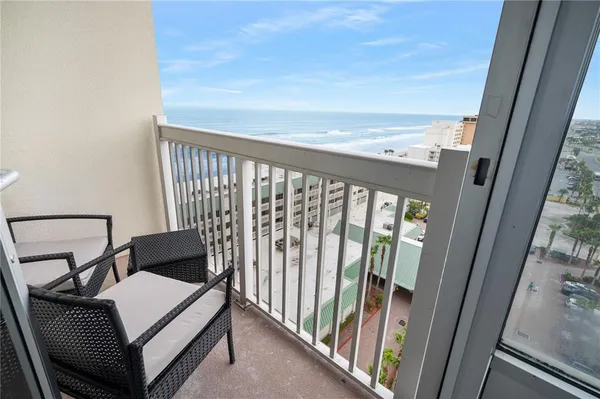 a view of a balcony with furniture