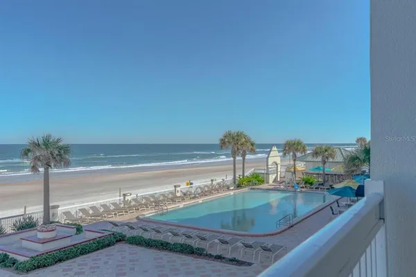 a view of a swimming pool with a yard