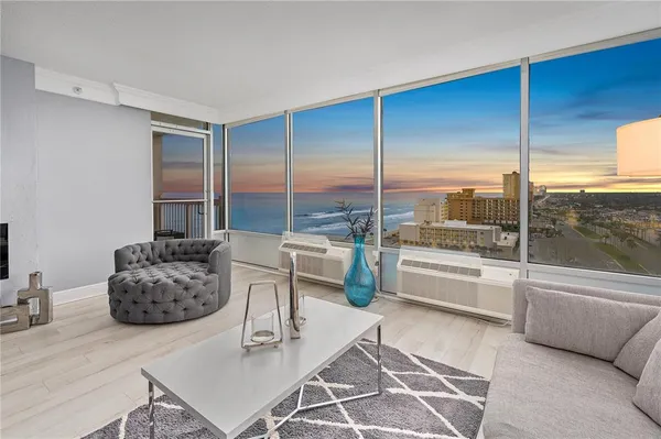 a living room with furniture and a floor to ceiling window
