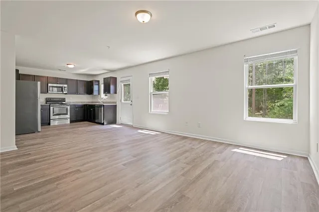 a big room with windows and cabinet