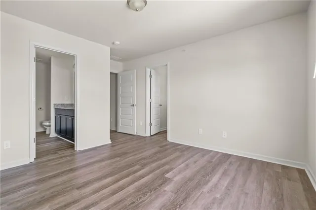 a view of an empty room and wooden floor