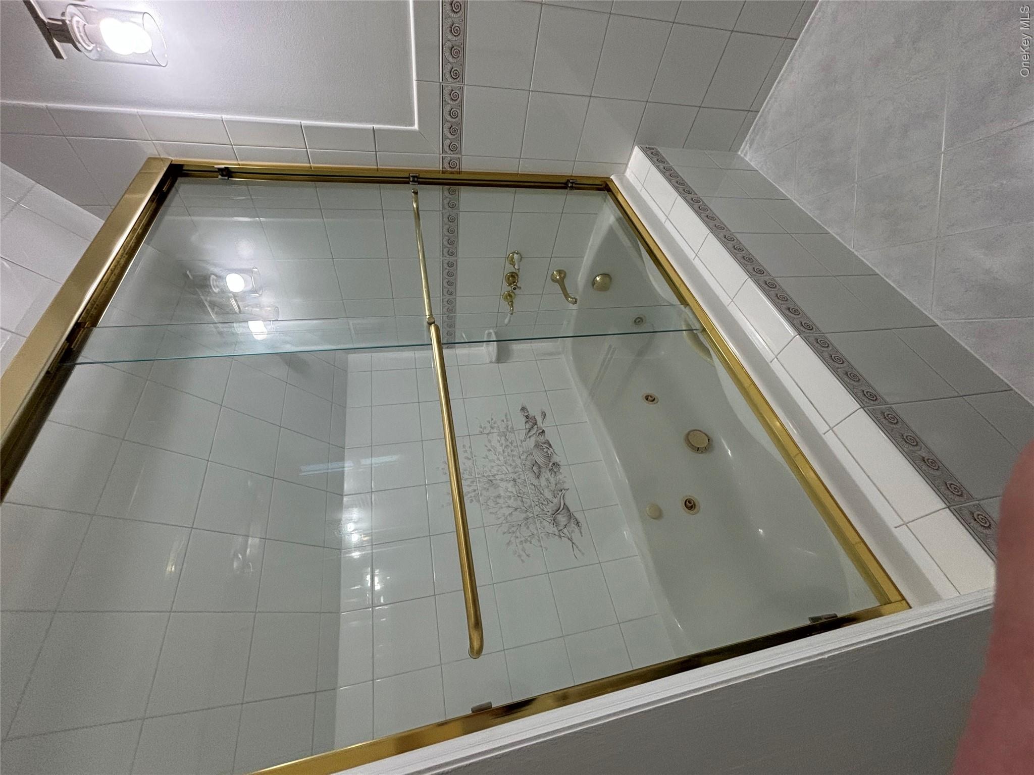 445 North Country Road St. James, NY 11780 - Photo 12 of 13 a bathroom with a shower and a mirror