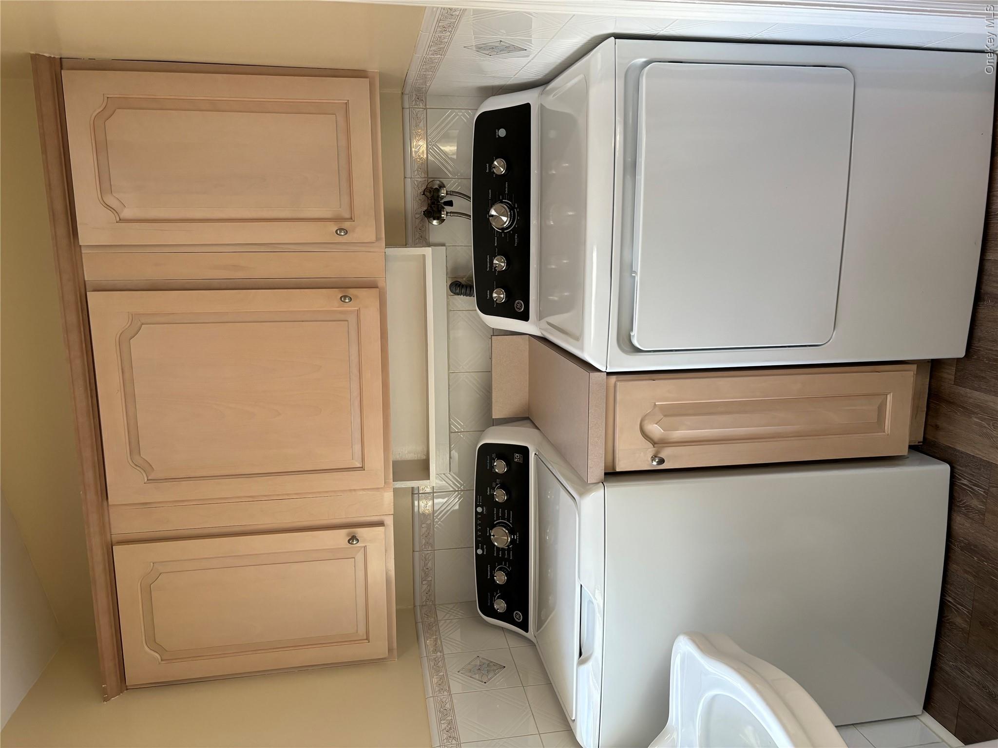 445 North Country Road St. James, NY 11780 - Photo 3 of 13 a kitchen with a stove and white cabinets