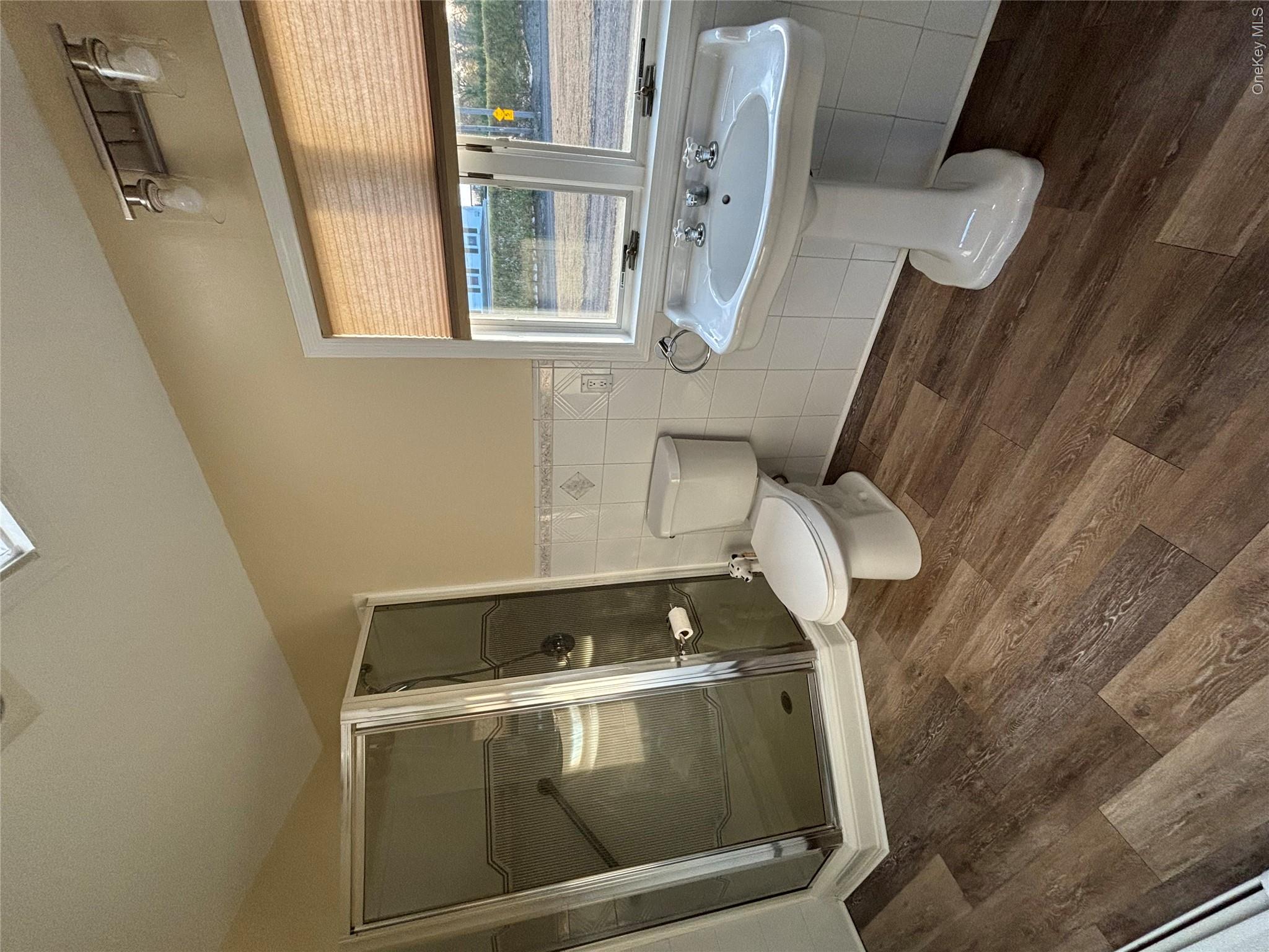 445 North Country Road St. James, NY 11780 - Photo 4 of 13 a bathroom with a sink toilet and shower
