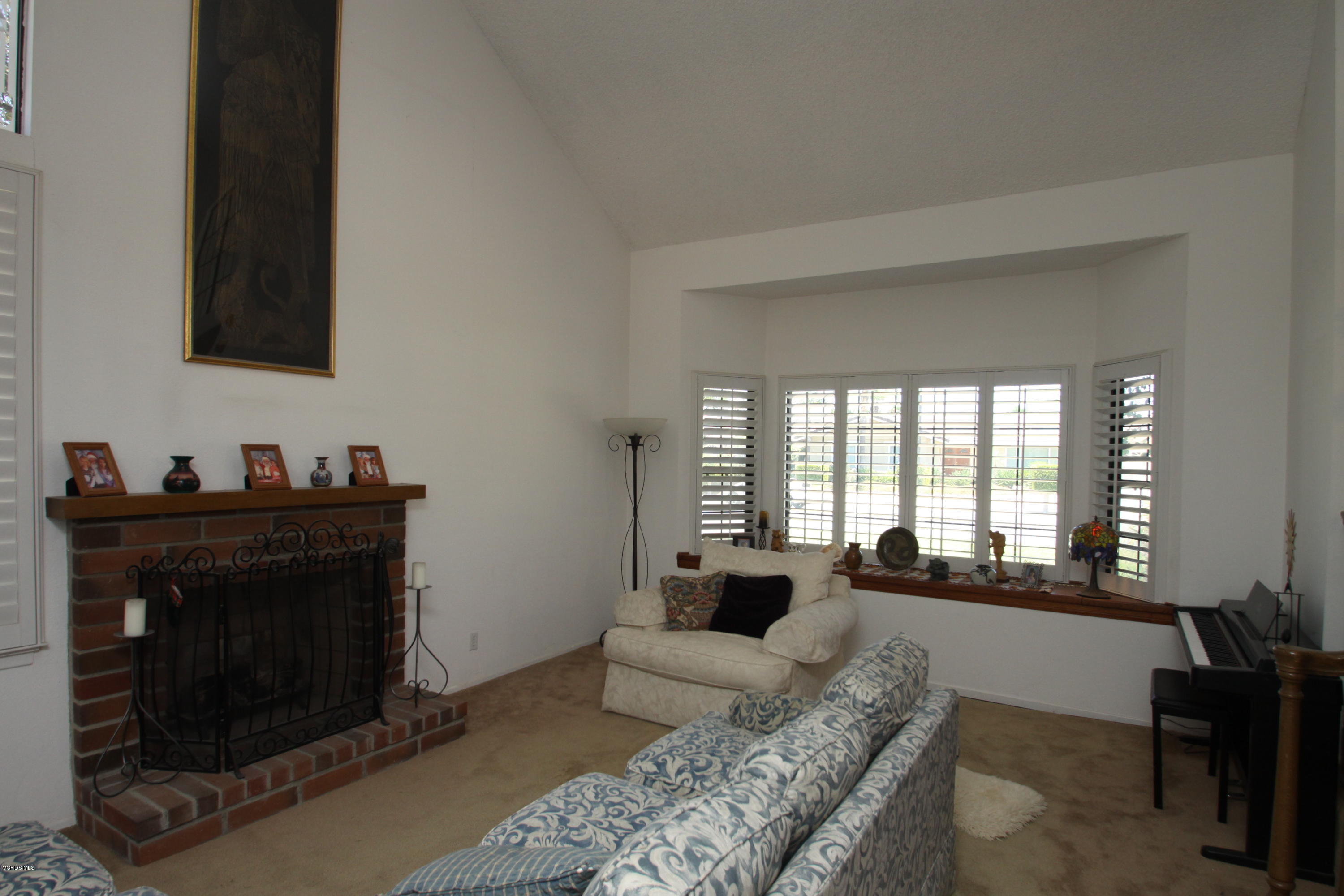 2136 McCrea Road Thousand Oaks, CA 91362 - Photo 11 of 26 a living room with furniture a fireplace and a large window