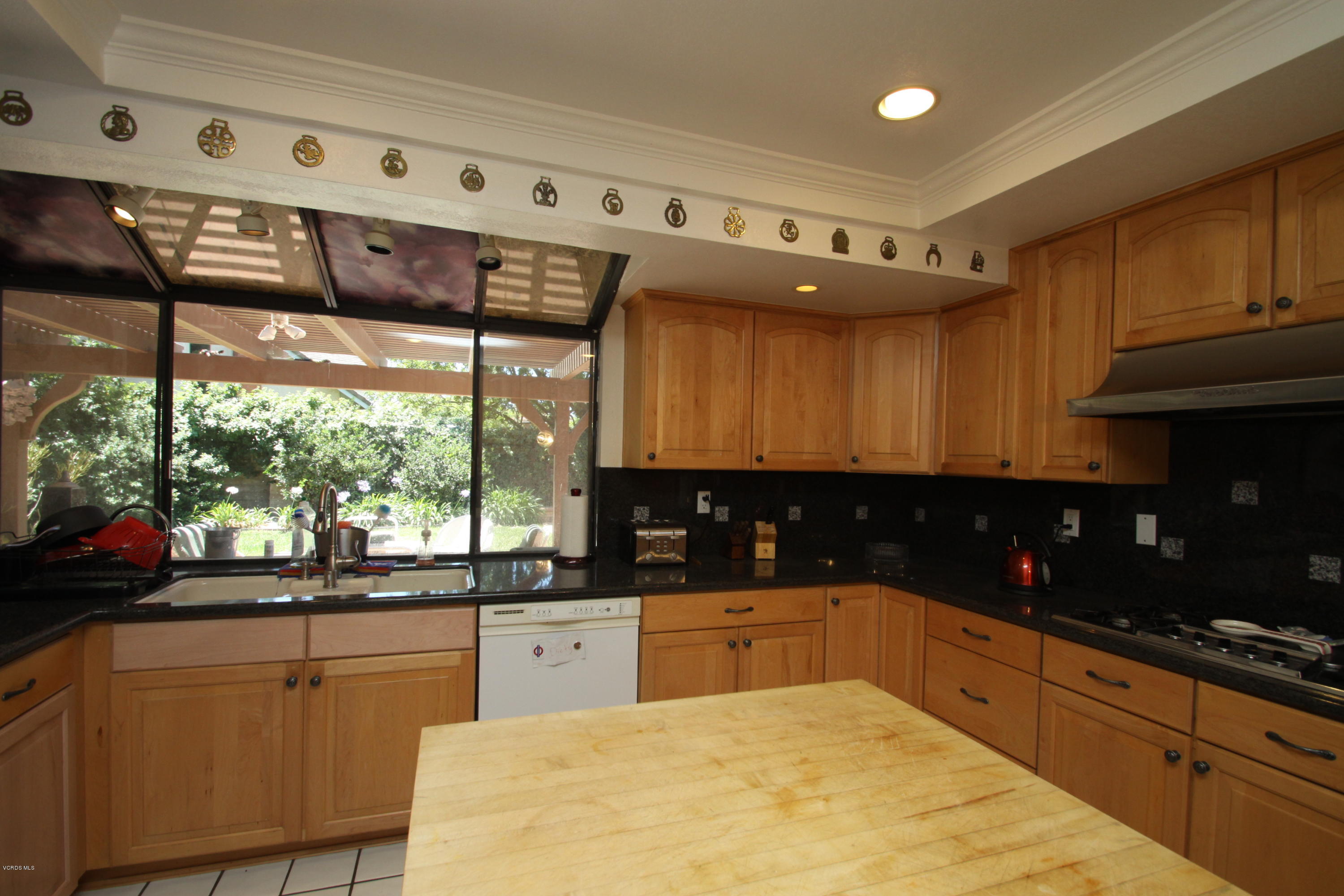 2136 McCrea Road Thousand Oaks, CA 91362 - Photo 4 of 26 a kitchen with stainless steel appliances kitchen island granite countertop a sink and cabinets