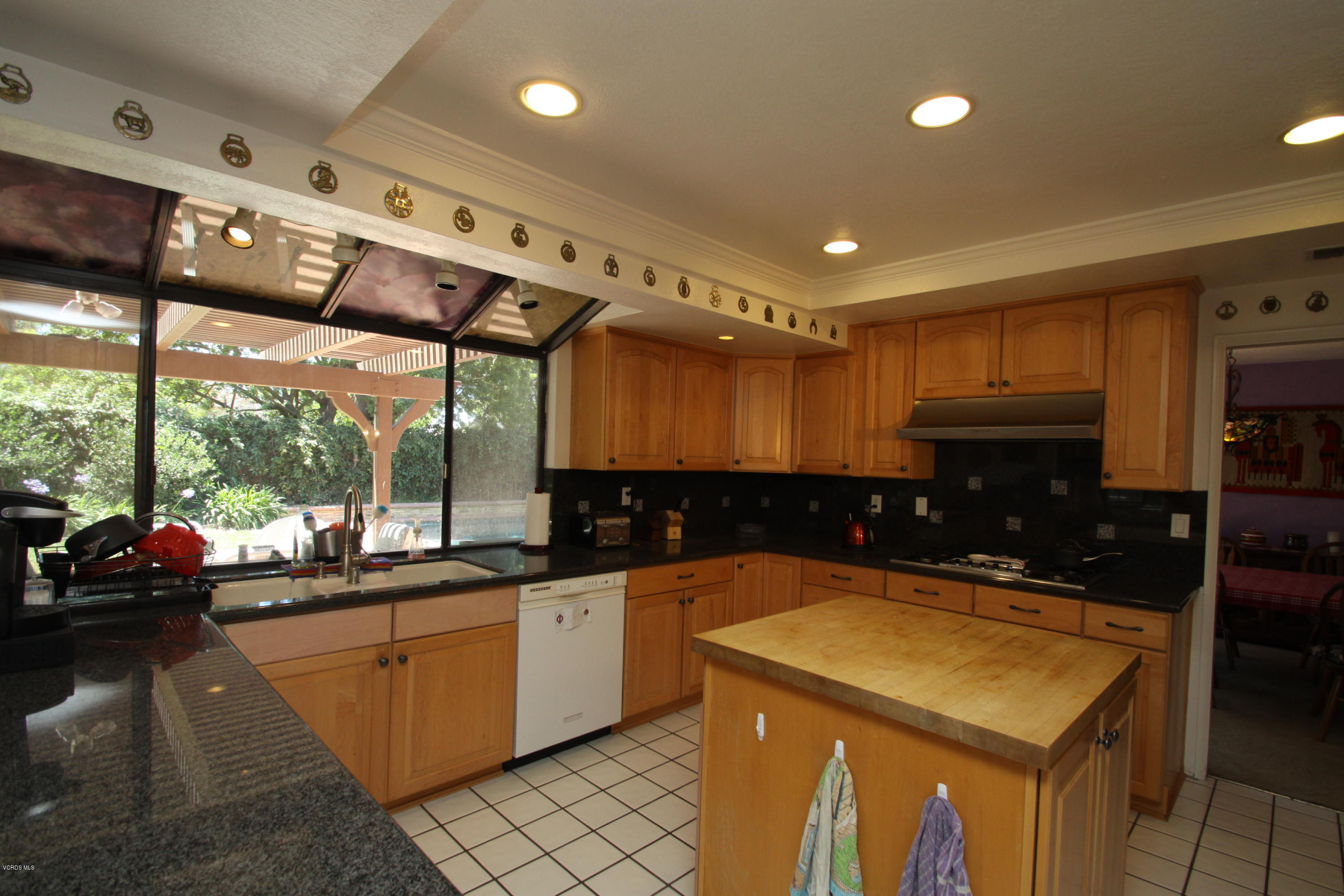 2136 McCrea Road Thousand Oaks, CA 91362 - Photo 5 of 26 a kitchen with a sink a counter top space stainless steel appliances and a large window